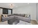 Comfortable living room with a large sectional, ottoman, and a decorative wall design at 6851 Roswell Rd # K-23, Atlanta, GA 30328