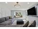 Stylish living room with a comfortable gray sectional, ottoman, and modern lighting at 6851 Roswell Rd # K-23, Atlanta, GA 30328