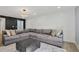 Comfortable living room with a large sectional couch and a sleek ottoman on a carpet at 6851 Roswell Rd # K-23, Atlanta, GA 30328