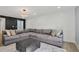 Spacious living room with plush sectional seating, ottoman, and contemporary decor at 6851 Roswell Rd # K-23, Atlanta, GA 30328