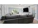 Bright living room with a large gray sectional sofa and a window seat at 6851 Roswell Rd # K-23, Atlanta, GA 30328