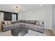 Open-concept living room featuring a contemporary rug and comfortable gray sectional sofa at 6851 Roswell Rd # K-23, Atlanta, GA 30328