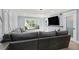 Modern living room showcasing a large sectional sofa and a window seat with natural light at 6851 Roswell Rd # K-23, Atlanta, GA 30328