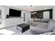 Airy living room with black accent wall, a gray sectional, and ample natural light at 6851 Roswell Rd # K-23, Atlanta, GA 30328