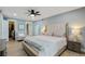 Spacious bedroom with a large bed, ceiling fan, walk-in closet, and natural light from the windows at 6851 Roswell Rd # K-23, Atlanta, GA 30328