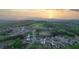 Panoramic aerial view of a meticulously planned community nestled within lush green hillsides at sunset at 237 Laurel Vista Dr, Canton, GA 30114
