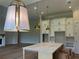 Spacious kitchen with an island, modern pendant lights, and ample white cabinetry at 237 Laurel Vista Dr, Canton, GA 30114