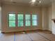 Living room with large windows offering views of the green outdoors at 237 Laurel Vista Dr, Canton, GA 30114