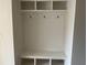 Newly built mudroom featuring three coat hooks, cubbies, and a bench at 237 Laurel Vista Dr, Canton, GA 30114