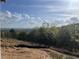 Exterior view from homesite overlooking mountains, trees, and blue skies at 237 Laurel Vista Dr, Canton, GA 30114