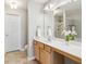 Bathroom with a large mirror, tiled floor, and bright light at 5221 Sherwood Way, Cumming, GA 30040