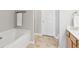 Bright bathroom featuring a bathtub, tiled floor, and a towel rack for added convenience at 5221 Sherwood Way, Cumming, GA 30040