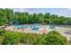 A Large community pool with a slide, splash pad, lounge chairs, and umbrellas at 5221 Sherwood Way, Cumming, GA 30040