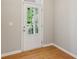 Bright entryway featuring a glass-paneled door and hardwood floors at 5221 Sherwood Way, Cumming, GA 30040