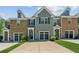 Charming townhome with a well-manicured lawn and attached garage at 5221 Sherwood Way, Cumming, GA 30040