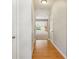 Hallway with hardwood floors leading to a bright living area at 5221 Sherwood Way, Cumming, GA 30040
