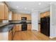 Kitchen with wooden floors and black appliances at 5221 Sherwood Way, Cumming, GA 30040