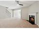 Spacious living room featuring a fireplace, ceiling fan, and staircase to the upper level at 5221 Sherwood Way, Cumming, GA 30040