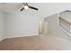 Open living room area with stairs and a ceiling fan at 5221 Sherwood Way, Cumming, GA 30040