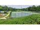 Well-maintained community tennis courts surrounded by fences and lush greenery at 5221 Sherwood Way, Cumming, GA 30040