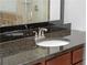 Bathroom features granite countertop with dark cabinetry, vessel sink, and modern faucet fixtures at 1102 Madison Ln # 1102, Smyrna, GA 30080