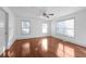 A bedroom showcasing hardwood floors, white walls, three windows, and a double-door closet at 1102 Madison Ln # 1102, Smyrna, GA 30080