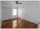 A bedroom featuring hardwood floors, white walls, a ceiling fan, and a double-door closet at 1102 Madison Ln # 1102, Smyrna, GA 30080