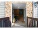 Condo entrance showcasing the wooden staircase and stone accent wall at 1102 Madison Ln # 1102, Smyrna, GA 30080