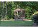 Charming gazebo in a backyard setting, surrounded by lush greenery and mature trees at 1102 Madison Ln # 1102, Smyrna, GA 30080