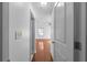 View of a hallway with hardwood floors leading to a bedroom with a window and ceiling fan at 1102 Madison Ln # 1102, Smyrna, GA 30080