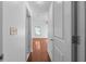 View of a hallway with hardwood floors leading to a bedroom with a window and ceiling fan at 1102 Madison Ln # 1102, Smyrna, GA 30080