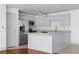 Well-lit kitchen featuring stainless steel appliances, light blue cabinets, and granite countertops at 1102 Madison Ln # 1102, Smyrna, GA 30080