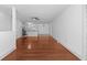 Open concept living room showcasing hardwood floors, neutral paint, and seamless flow to the kitchen at 1102 Madison Ln # 1102, Smyrna, GA 30080