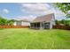 Lush green backyard with a fenced perimeter and view of a charming home at 1809 Hanwoo Ln, Powder Springs, GA 30127