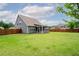 Vast backyard featuring a well-maintained lawn and a covered patio area at 1809 Hanwoo Ln, Powder Springs, GA 30127