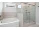 Modern bathroom featuring a glass shower, soaking tub, neutral tiles and finishes at 1809 Hanwoo Ln, Powder Springs, GA 30127