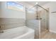 Bright bathroom showcasing a glass-enclosed shower, soaking tub, and modern tiled surround at 1809 Hanwoo Ln, Powder Springs, GA 30127