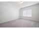 A spacious bedroom with neutral carpet and plenty of natural light from the window at 1809 Hanwoo Ln, Powder Springs, GA 30127