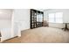 Bright bonus room featuring built-in bookshelves and carpet for a warm and inviting atmosphere at 1809 Hanwoo Ln, Powder Springs, GA 30127