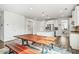 Spacious dining area featuring a large wooden table, light gray flooring, and modern lighting at 1809 Hanwoo Ln, Powder Springs, GA 30127