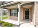 Close-up of charming front porch and craftsman style door at 1809 Hanwoo Ln, Powder Springs, GA 30127