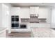 Modern kitchen featuring stainless steel appliances, granite countertops, and ample white cabinetry at 1809 Hanwoo Ln, Powder Springs, GA 30127