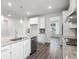Well-lit kitchen with granite counters, stainless appliances, an island, and sleek tile backsplash at 1809 Hanwoo Ln, Powder Springs, GA 30127