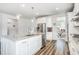 Bright, modern kitchen with stainless steel appliances, a large island, granite countertops, and stylish pendant lights at 1809 Hanwoo Ln, Powder Springs, GA 30127