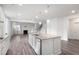 Open-concept kitchen with stainless steel appliances, large island, granite counters, and views to the living room at 1809 Hanwoo Ln, Powder Springs, GA 30127