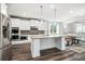 Contemporary kitchen and dining area featuring stainless steel appliances and a large island with granite countertops at 1809 Hanwoo Ln, Powder Springs, GA 30127