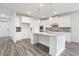 Well-equipped kitchen boasting white cabinets, a granite island, and modern stainless steel appliances at 1809 Hanwoo Ln, Powder Springs, GA 30127