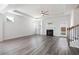 Open living room showcasing a fireplace, ceiling fan, light gray floors and ample space at 1809 Hanwoo Ln, Powder Springs, GA 30127