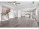 Open-concept living room features beautiful laminate floors leading to a modern kitchen and stairway at 1809 Hanwoo Ln, Powder Springs, GA 30127