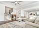 Bright living room with plush sectional sofa, laminate floors and stairway at 1809 Hanwoo Ln, Powder Springs, GA 30127